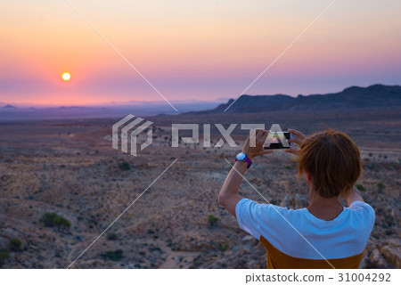 Tourist photographing with smartphone 31004292