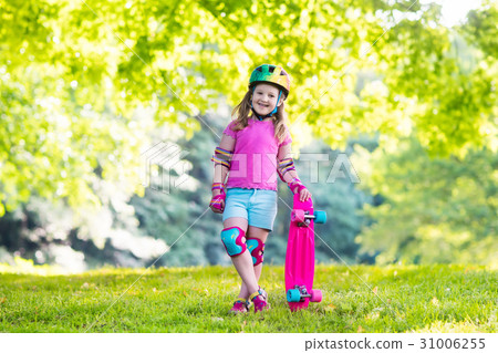 Child riding skateboard in summer park 31006255