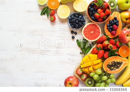 Rainbow fruits top view on white 31008369
