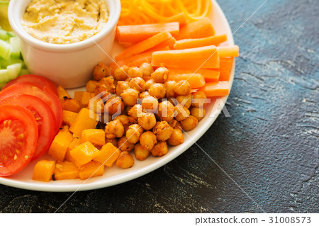 Healthy cut vegetables on the blue table Healthy cut vegetables on the blue table 31008573