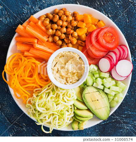Healthy cut vegetables on the blue table Healthy cut vegetables on the blue table 31008574