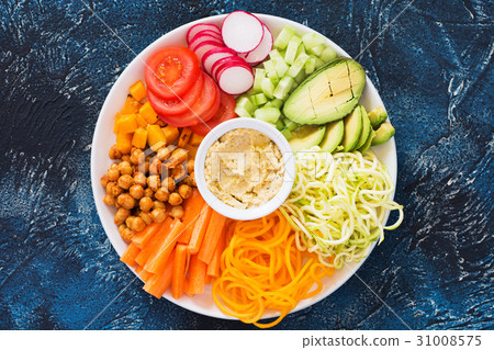 Healthy cut vegetables on the blue table Healthy cut vegetables on the blue table 31008575