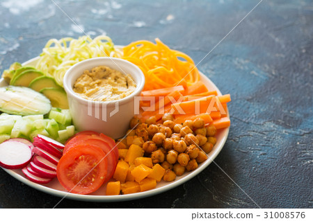 Healthy cut vegetables on the blue table Healthy cut vegetables on the blue table 31008576