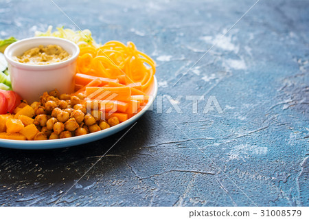 Healthy cut vegetables on the blue table Healthy cut vegetables on the blue table 31008579