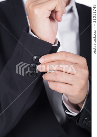 hand in black suit is dressing up hand in black suit is dressing up 31011749