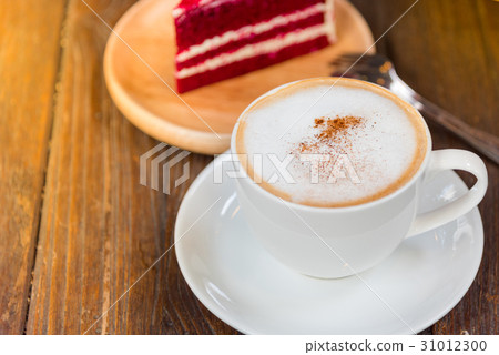 A cup of  coffee and a piece of cake. 31012300