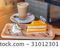 A cup of  coffee and a piece of cake. 31012301