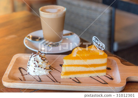 A cup of  coffee and a piece of cake. 31012301