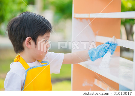 Asian children paiting wooden shelf outdoors 31013017