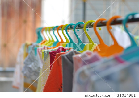 The colorful hangers are arranged in a neat The colorful hangers are arranged in a neat 31014991