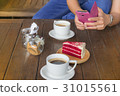 Hand holding mobile phone and a cup of coffee 31015561