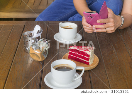 Hand holding mobile phone and a cup of coffee 31015561