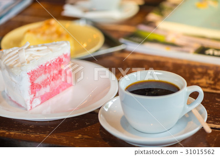 A cup of coffee and a piece of cake. A cup of coffee and a piece of cake. 31015562