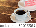 A cup of  coffee and a piece of cake. 31015563