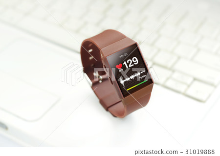 Heart rate on smartwatch screen,on keyboard laptop 31019888