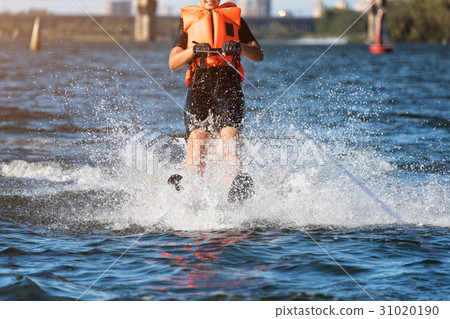 Woman riding water skis closeup. Body parts 31020190