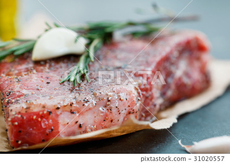Close-up of raw beef steak on craft paper with 31020557