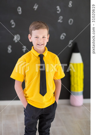 Cute handsome school boy in yellow t-shirt tie and 31020619