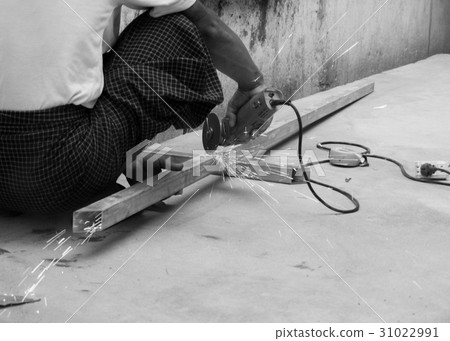 WORKER CUTTING STEEL WITH ELECTRIC WHEEL GRINDER WORKER CUTTING STEEL WITH ELECTRIC WHEEL GRINDER 31022991