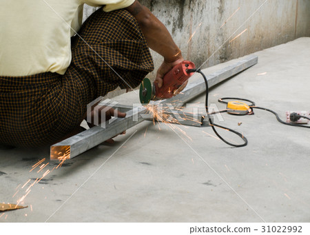 WORKER CUTTING STEEL WITH ELECTRIC WHEEL GRINDER WORKER CUTTING STEEL WITH ELECTRIC WHEEL GRINDER 31022992