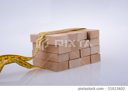 Yellow color measuring tape and domino 31023602