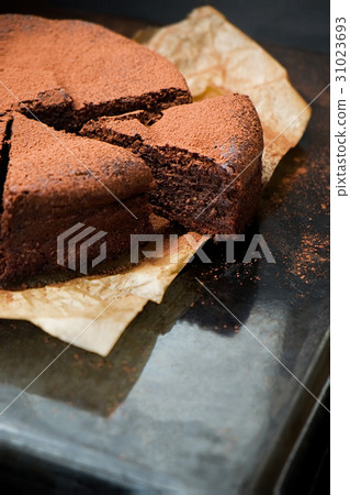 Chocolate cake cut with cocoa powder 31023693