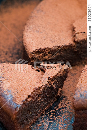 Chocolate cake cut with cocoa powder 31023694