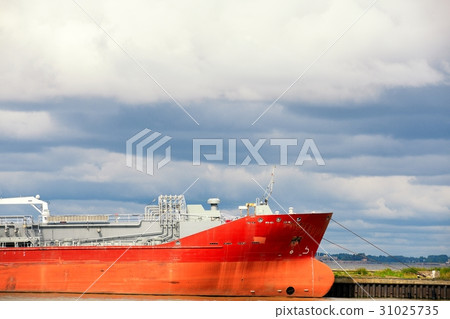 The huge red tanker moored in harbor The huge red tanker moored in harbor 31025735