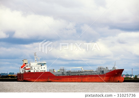 The huge red tanker moored in harbor 31025736