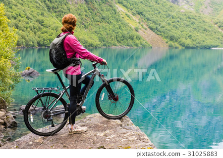 Biking in Norway against picturesque landscape 31025883
