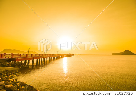 Sunrise over the sea with bridge and lighthouse Sunrise over the sea with bridge and lighthouse 31027729