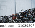 Bicycles parking near the white wall building 31029807