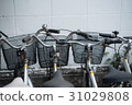 Bicycles parking near the white wall building 31029808