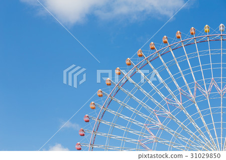 Giant funfair ferris wheel against clear blue sky Giant funfair ferris wheel against clear blue sky 31029850