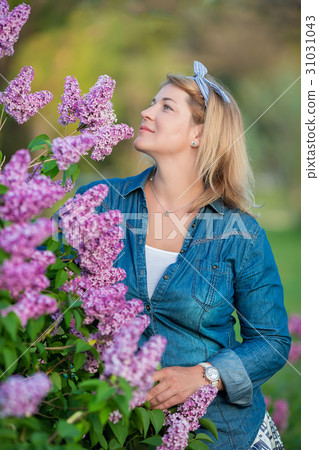 Beautiful woman with lilac bunch and wreath of Beautiful woman with lilac bunch and wreath of 31031043