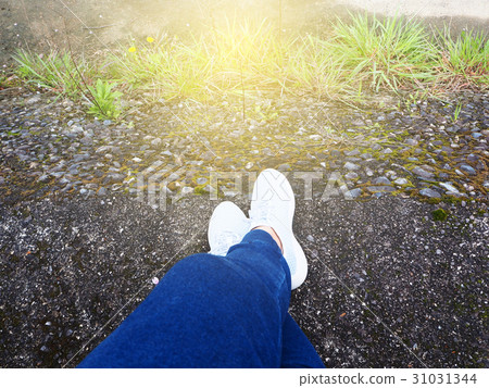 White shoe on feet of traveller on the rock floor White shoe on feet of traveller on the rock floor 31031344