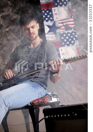 Young handsome musician playing electric guitar on 31033537
