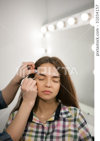 Brow master working with woman eyebrows 31034157