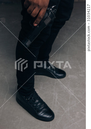 Unrecognizable black criminal with gun closeup Unrecognizable black criminal with gun closeup 31034217
