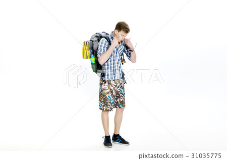 Young hiker with backpack on a white background 31035775