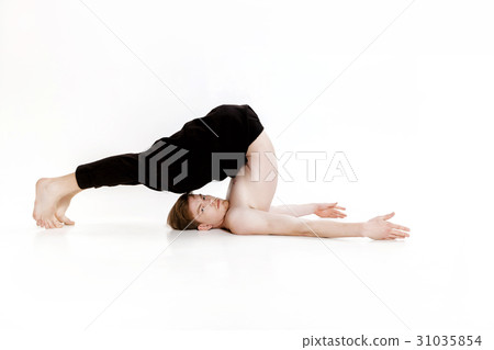 Young man doing yoga exercises. Studio shot on 31035854