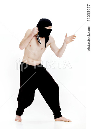 ninja man holds knife and is ready to attack on ninja man holds knife and is ready to attack on 31035977