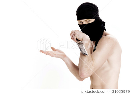 ninja man holds knife and is ready to attack on 31035979