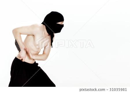 ninja man holds knife and is ready to attack on 31035981