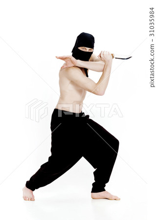 ninja man holds knife and is ready to attack on ninja man holds knife and is ready to attack on 31035984