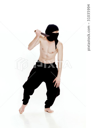 ninja man holds knife and is ready to attack on 31035994