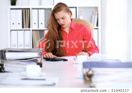 Business woman in red blouse making report Business woman in red blouse making report 31040157
