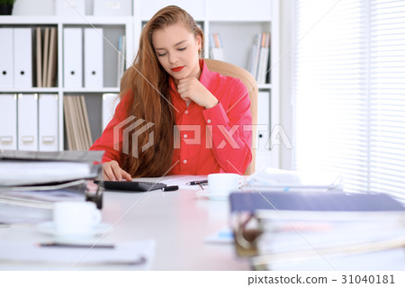 Business woman in red blouse making report Business woman in red blouse making report 31040181