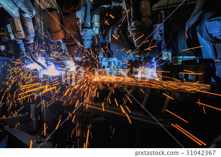 Industrial welding robots are movement in factory Industrial welding robots are movement in factory 31042367