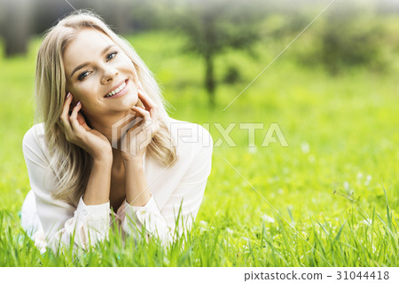 Blond girl relaxing in park 31044418